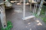 Empty Wooden Swing In The Garden Stock Photo