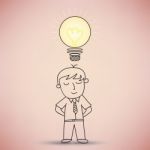 Businessman With Idea Light Bulb Stock Photo