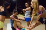 Group Of Girls Doing Stretching At Night Stock Photo