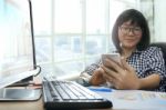 Asian Working Woman Looking To Smart Phone And Smiling Happiness Emotion For Office Life Theme Stock Photo