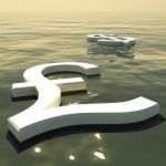 Pound And Dollar Floating In Sea Stock Photo