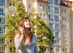 Young Beautiful Woman Playing Badminton Stock Photo