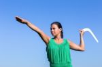 Dutch Woman Throwing Boomerang In Blue Sky Stock Photo