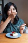 Young Woman Enjoy With A Cake In Cafe Stock Photo