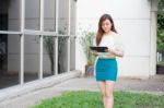 Portrait Of Thai Adult Businesswoman Beautiful Girl Using Her Tablet Stock Photo