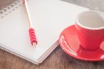 Red Mug With Open Notebook Stock Photo