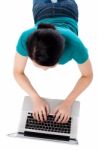 Aerial Shot Of A Girl Working On Laptop Stock Photo