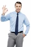 Team Leader Gesturing Okay Sign To His Subordinates Stock Photo