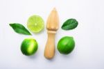 Fresh Limes And Wooden Juicer On White Background. Top View With Stock Photo