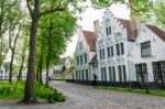 Bruges, Belgium - May 11, 2015: People Visit White Houses In The Stock Photo