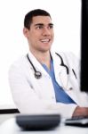 Smiling Young Doctor At His Office Stock Photo