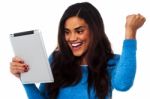 Excited Woman Holding Touch Pad Stock Photo