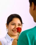 Boy Giving His Girlfriend Red Rose Stock Photo