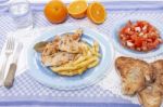 Turkey Steak With French Fries And Tomato Salad Stock Photo