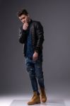 Casual Young Man In Black Leather Jacket And Denim Jeans Stock Photo