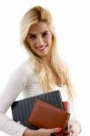 Side View Of Smiling Young Student Holding Books Stock Photo