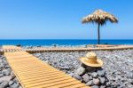 Portuguese Stony Beach With Path Sea Hat And Parasol Stock Photo