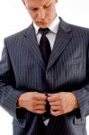 Businessman Buttoning His Jacket Stock Photo