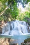 The Water Flowing Over Rocks And Trees Down A Waterfall At Huay Mae Khamin Waterfall National Park ,kanchana Buri In Thailand Stock Photo