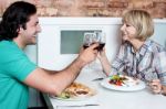 Couple Toasting Over A Restaurant Table Stock Photo