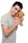 Man Cludding Teddy Bear Stock Photo