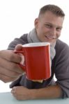 Young Man Showing Coffee Mug Stock Photo