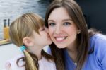 Child Giving A Kiss To His Mother On The Cheek Stock Photo