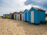 A Row Of Brightly Coloured Beach Huts In Southwold Stock Photo