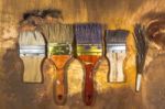 Oil Paint Brushes On Wood Painted Background Stock Photo