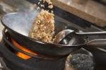 Stir fried rice being cooked in wok Stock Photo