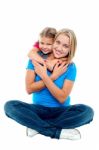 Cute Daughter Hugging Her Mother From Behind Stock Photo