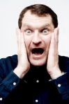 Man With Shocked Facial Expression Stock Photo