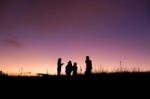 Silhouette People On Top Of Mountain Stock Photo