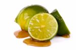 Green Limes With Honey Stock Photo