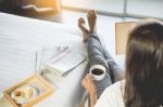 Woman Reading Book Or Newspaper And Drinking Coffee Breakfast On Stock Photo