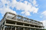 New High Construction Building Framing Against Blue Sky Stock Photo