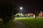 Night Public Park In The City With Houses Near Stock Photo