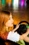 Beautiful Girl In An Electric Bumper Car At Amusement Park Stock Photo