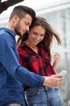 Young Couple Using Smart Phone Stock Photo