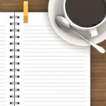 White Cup Of Hot Coffee And White Sketch Book On Wood Table Stock Photo