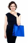 Young Shopaholic Woman Carrying Bright Bag Stock Photo