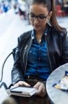 Beautiful Young Woman Reading A Book In The Street Stock Photo