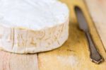 Camembert Cheese And Vintage Knife On Wooden Table Stock Photo