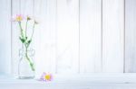 Daisies In Vase On A Old Wooden Table Stock Photo