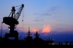 Cranes In Dockside At Sunset Stock Photo