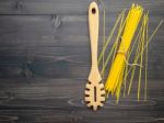 The Thin Spaghetti On Black Wooden Background. Yellow Italian Pa Stock Photo