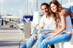 Couple Sitting On Foot Bridge Stock Photo