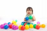 Baby Girl Is Playing Ball On White Background Stock Photo