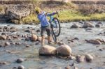 Cyclist Crossing Rio Humuya In Honduras Stock Photo