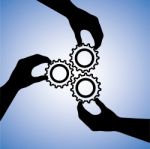 Silhouette Hand Holding Cog Gear Stock Photo